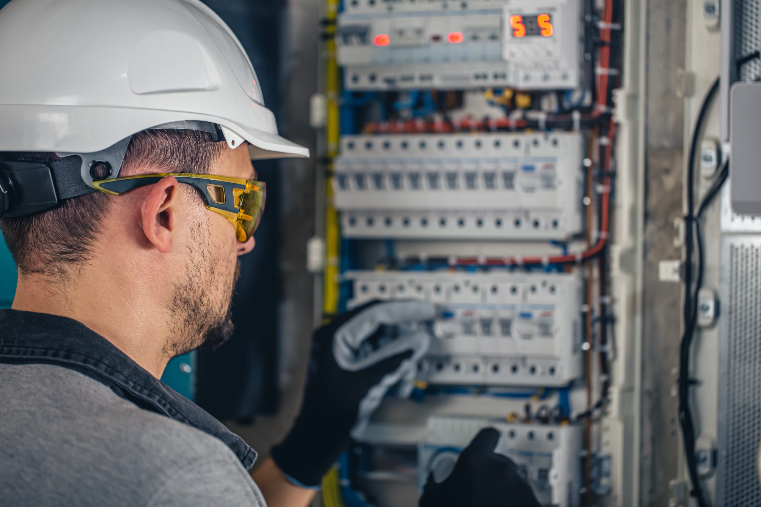 man-electrical-technician-working-switchboard-with-fuses.jpg